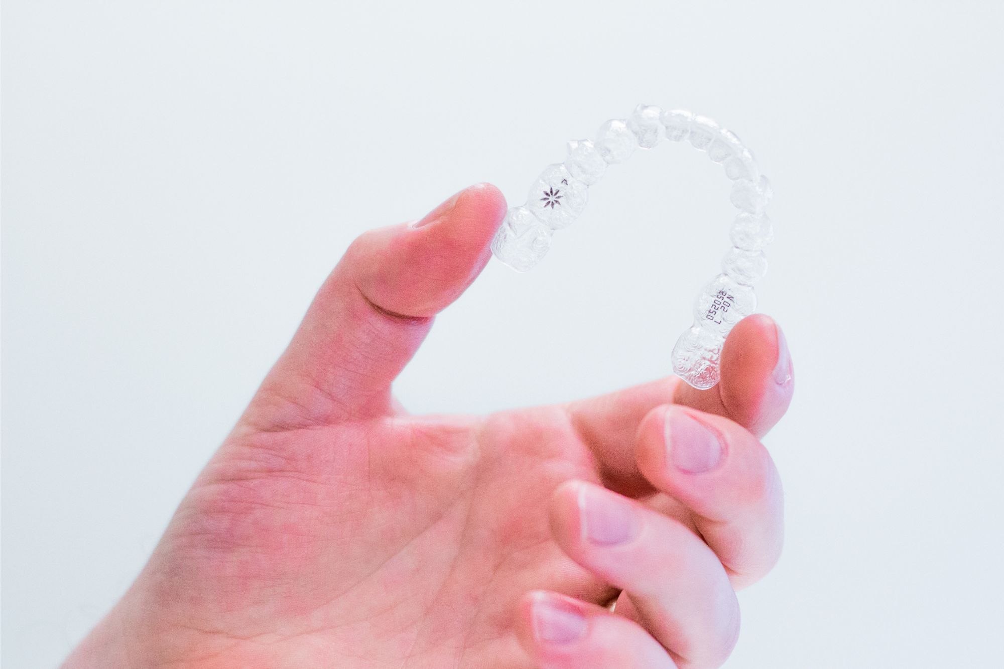 hand-holding-invisalign-aligners Free Consultation