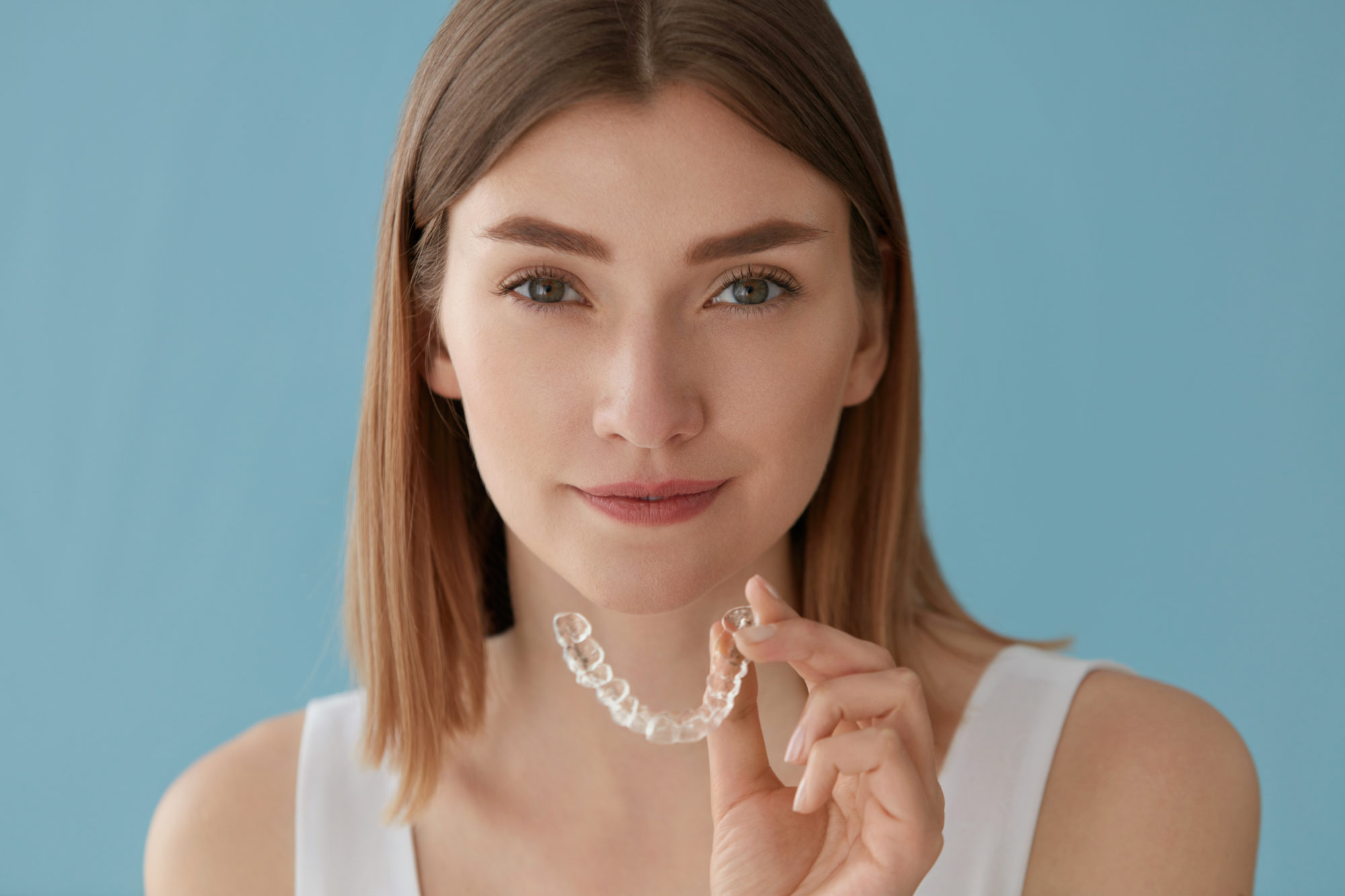 Teeth whitening. Woman with healthy teeth using removable braces Invisalign Greenwood Village